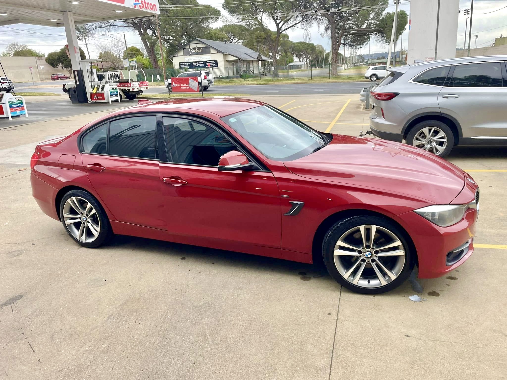 A freshly washed red BMW on the forecourt at Turvey Park