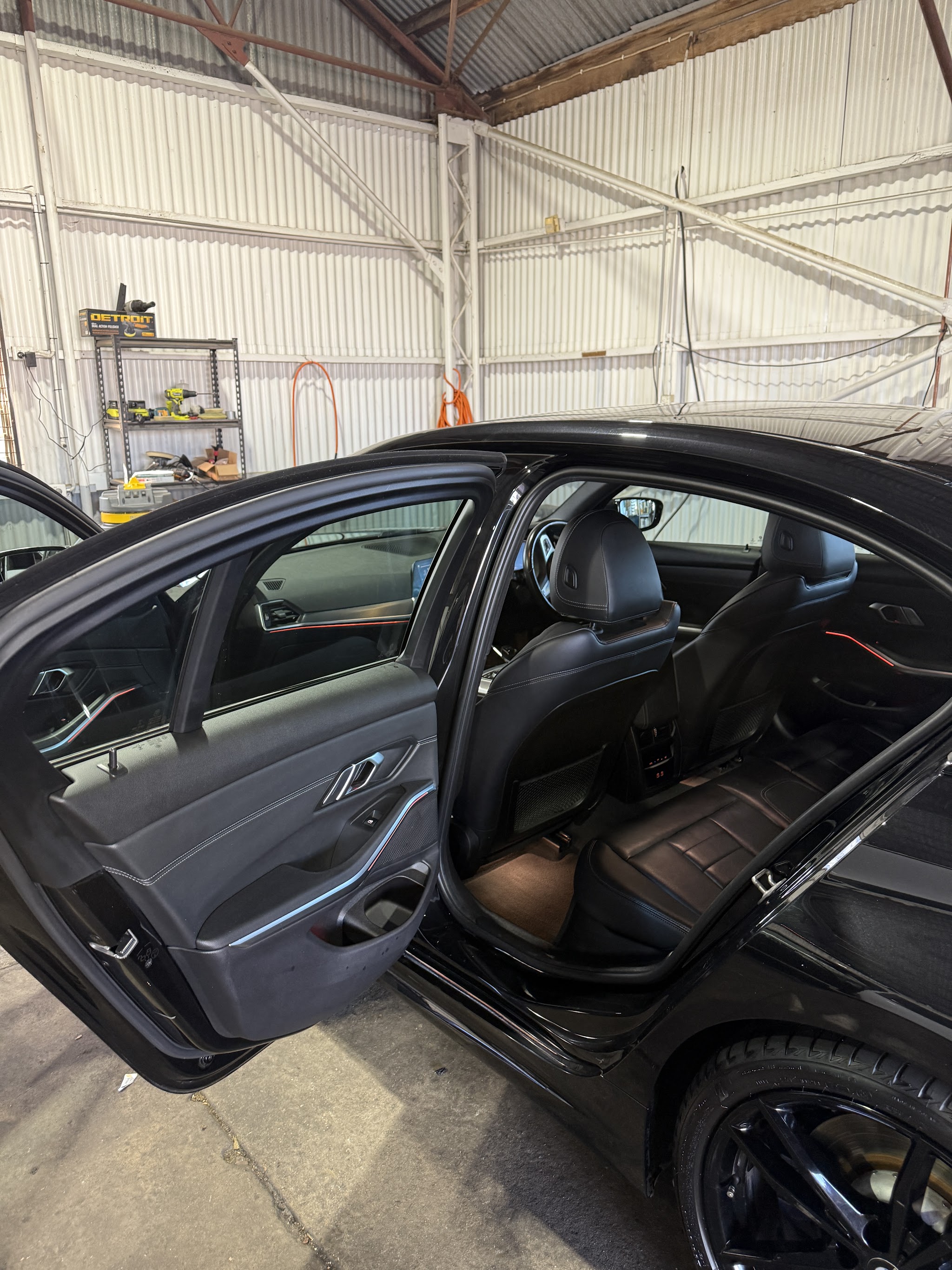 The interior of a detailed BMW with the rear door open